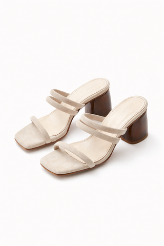 Beige high-heeled sandals on a white background