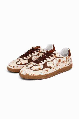 Pair of brown and white sneakers on a white background