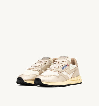 Autry Reelwind women’s sneakers in gold tone nylon with metallic leather detailing, retro runner silhouette with cushioned sole and branded tongue.