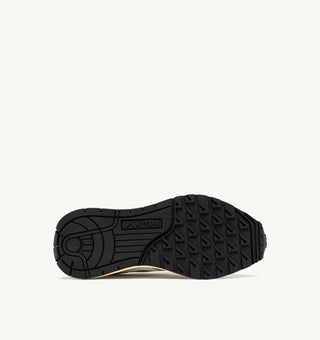 Autry Reelwind women’s sneakers in gold tone nylon with metallic leather detailing, retro runner silhouette with cushioned sole and branded tongue.