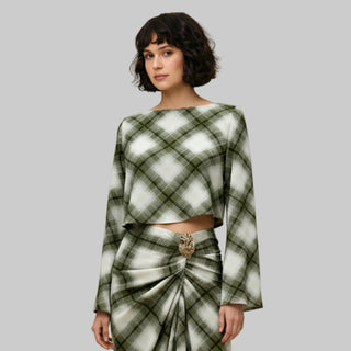 Woman wearing a green and white plaid outfit with a beige background