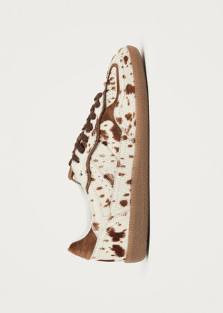 Sneaker with brown speckles on a white background