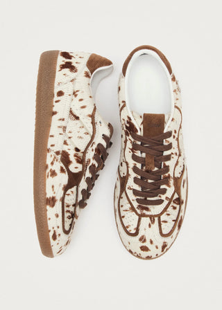Pair of sneakers with a brown and white pattern on a light gray background