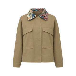 A cropped utility jacket in tan canvas with a contrasting floral print collar, featuring two large front flap pockets, shown against a plain white background.