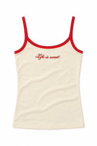 An off-white ribbed camisole tank top with red trim along the straps and neckline, featuring the phrase 'Life is sweet' embroidered in red script across the chest.