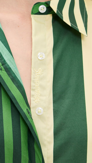 Simon Miller Loch Poplin Button Up Top in green striped combo featuring a collared neckline, long sleeves, button front, and adjustable tie back detail on model