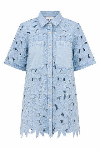 Blue denim shirt dress with cut-out patterns on a white background