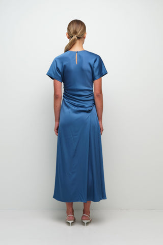 washed indigo satin midi dress, simkhai marabella dress front view, draped midi dress with ruching, short sleeve satin midi dress, side slit blue midi dress, luxury women’s satin dress, elevated occasion midi dress
