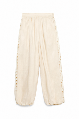 Beige wide-leg pants with decorative trim on a white background