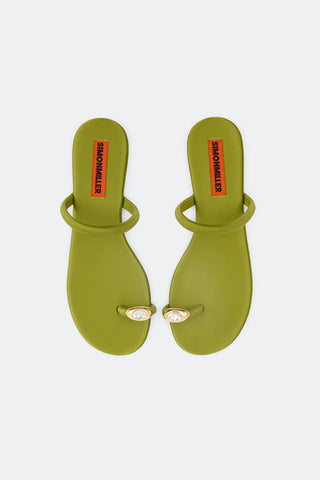 Pair of green sandals with decorative eyelets on a white background