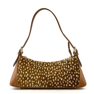 A brown shoulder bag with a white spotted animal print center panel and smooth brown leather sides and strap, shown on a plain white background.