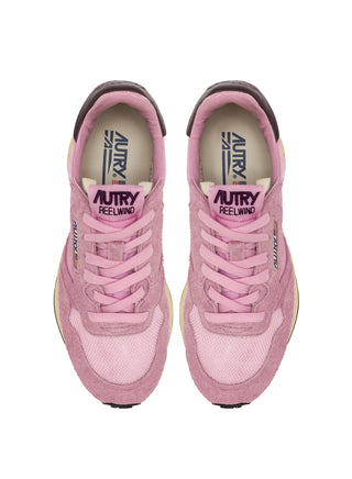 Women’s Autry Reelwind sneakers in rose suede and nylon with brown leather side accents, washed finish, and retro runner sole with star tread.