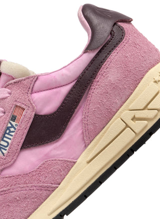 Women’s Autry Reelwind sneakers in rose suede and nylon with brown leather side accents, washed finish, and retro runner sole with star tread.