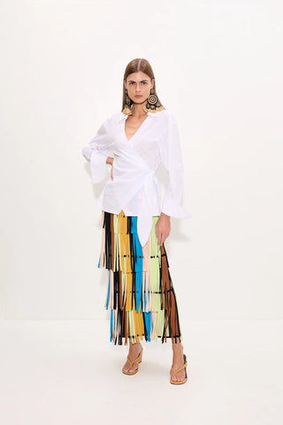 Woman wearing a white blouse and colorful striped skirt on a white background