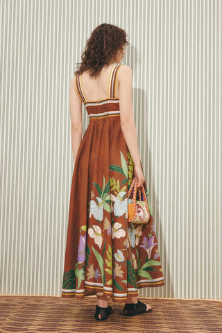 Woman wearing a floral dress with a striped background