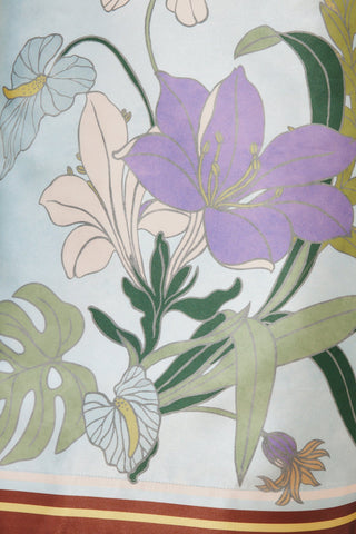 Floral pattern with purple and white flowers on a light blue background