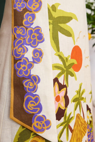 Close-up of a colorful fabric with floral and nature-themed patterns.
