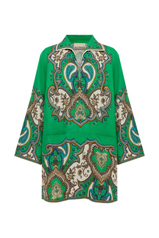A green button-up shirt with a large, ornate paisley and floral pattern in beige, teal, and brown, featuring a pointed collar and wide sleeves, shown against a plain white background.