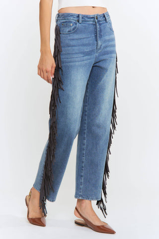 Blue jeans with fringe details on a white background