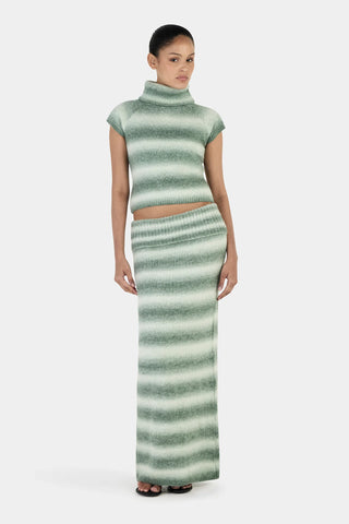 Woman wearing a green and white striped outfit on a white background