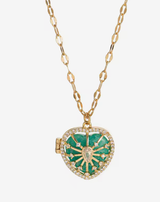 Heart-shaped locket with green enamel and gold accents on a gold chain against a white background