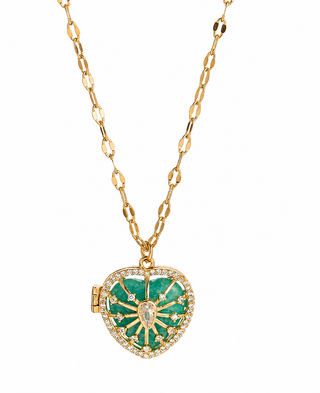 A gold chain necklace with a heart-shaped locket pendant featuring green enamel and a halo of small clear stones, shown on a plain white background.