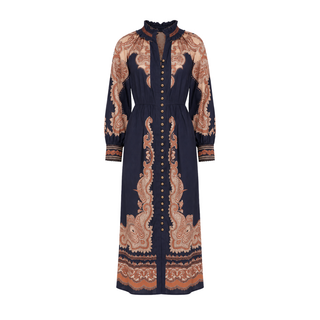 A long-sleeved midi dress with a high ruffled collar and a button-down front, featuring a navy blue base with a prominent copper-brown paisley pattern.
