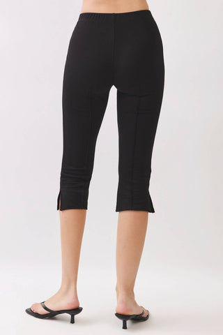 Black capri pants worn by a person on a white background