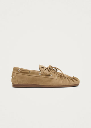 Brown suede loafer shoe on a light beige background