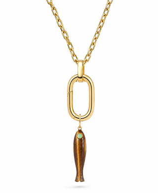 A gold chain necklace featuring a large open oval pendant with a dangling fish charm. The fish charm has a polished gold body with a small green-blue stone set in its head, all shown against a plain white background.